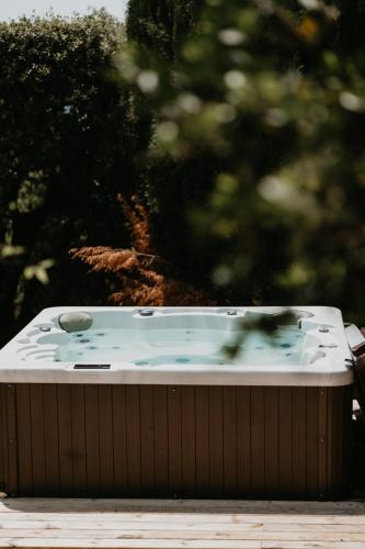 a jacuzzi tub sitting on a wooden deck at Le Cigalon in Le Beausset