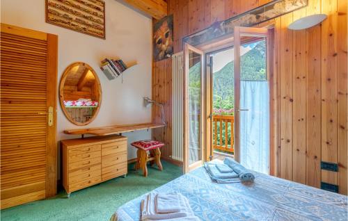 a bedroom with a bed and a mirror and a window at Le Coeur De Lea in Champoluc