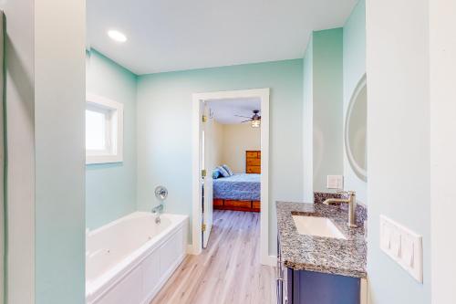 a bathroom with a tub and a bedroom with a bed at The Owl's Nest in Old Orchard Beach