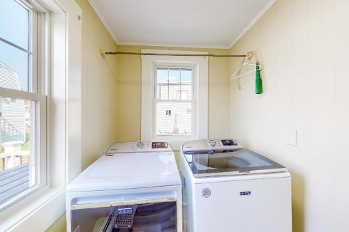 a washer and dryer in a room with a window at The Owl's Nest in Old Orchard Beach