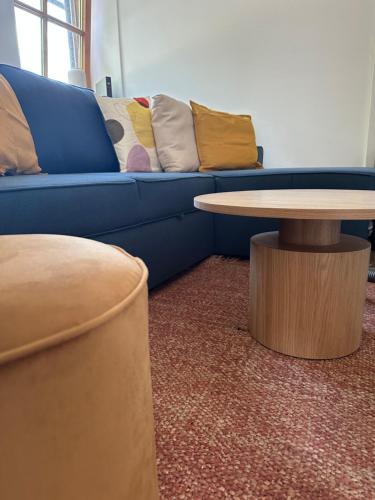 a blue couch with pillows and a table in a room at Seeapartment in Prien am Chiemsee