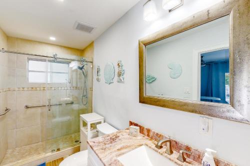 a bathroom with a sink and a shower and a mirror at Sunny Bank in Marathon