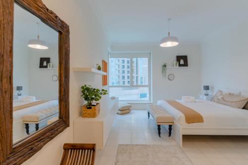 1 dormitorio con espejo grande, cama y bañera en LUXFolio Retreats - Astonishing 3BHk Apartment, en Dubái