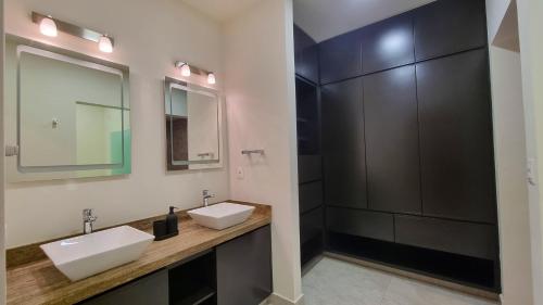 a bathroom with two sinks and a mirror at Palacio Huatulco - 2I in Santa Maria Huatulco