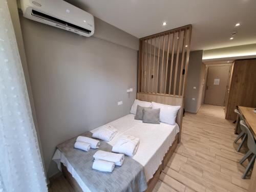 a bedroom with a bed with towels on it at Xanthi Apartments in Katerini