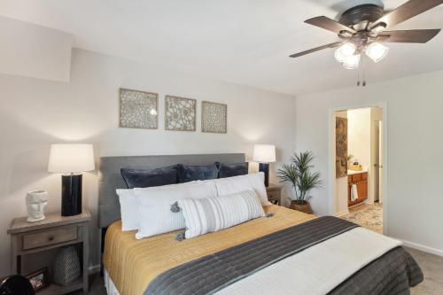 a bedroom with a bed with a ceiling fan at Overland Park Condo, Close to Lakes and Parks! in Overland Park
