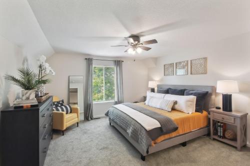a bedroom with a bed and a ceiling fan at Overland Park Condo, Close to Lakes and Parks! in Overland Park