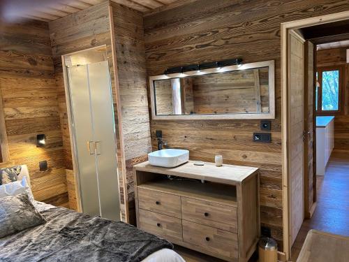 a bathroom with a sink in a log cabin at Le cerf majestueux, Bolquere in Bolquere Pyrenees 2000