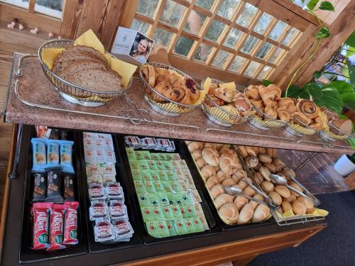 a display case with different types of bread and pastries at Haiminger Hof in Haiming
