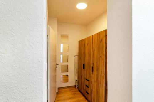 a hallway with a wooden cabinet in a room at Ferienhaus Sonnenschein - Wohnung 1 in Norden