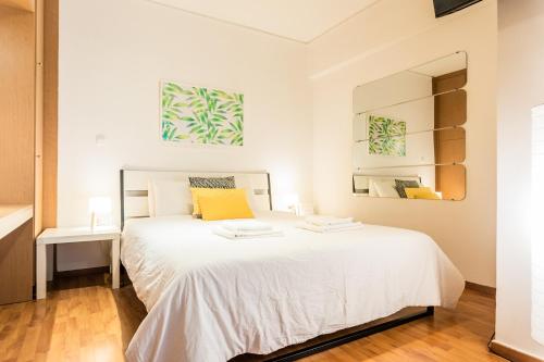 a bedroom with a white bed and a mirror at Beautiful Studio - Heart of Athens in Athens
