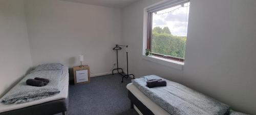 a bedroom with two beds and a window at Family-friendly house close to Aarhus in Galten