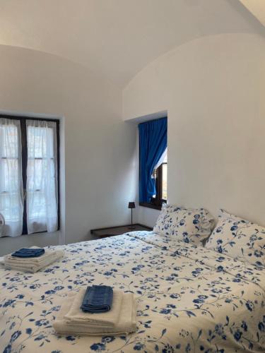a bedroom with a bed with a blue and white comforter at Penthouse Cala Gavetta in La Maddalena