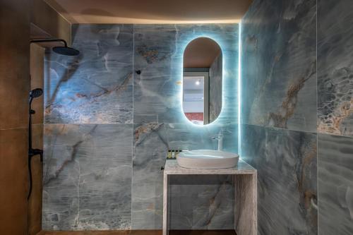 a bathroom with a sink and a mirror at Palazzo di Sitia Luxury Suites in Sitia