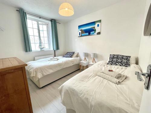 a bedroom with two beds and a couch in it at Apartment in central Exmouth in Exmouth