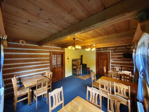 a dining room with wooden walls and a table and chairs at Horská chata Boubelka in Pec pod Sněžkou