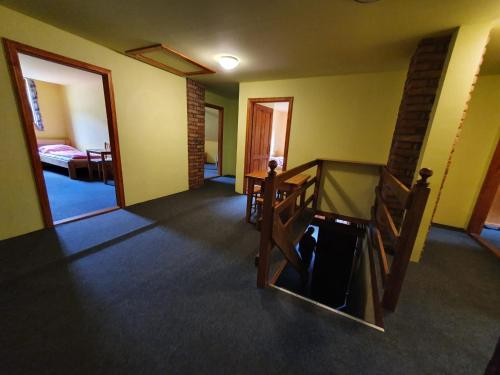 an empty room with a staircase and a bedroom at Horská chata Boubelka in Pec pod Sněžkou