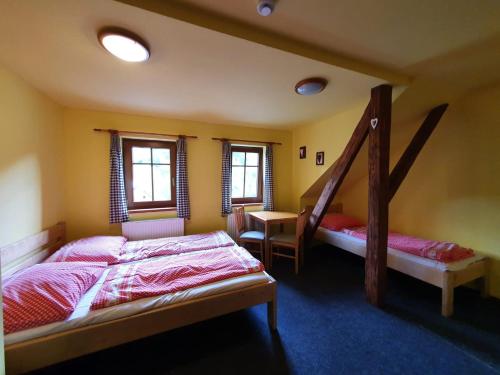 a bedroom with two bunk beds and a staircase at Horská chata Boubelka in Pec pod Sněžkou