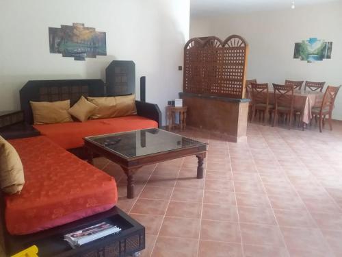 a living room with a couch and a coffee table at location vacance sidi bouzid in Sidi Bouzid