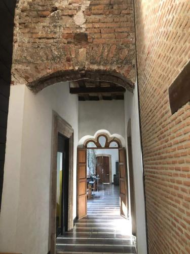 an archway in a building with a brick wall at Elena de Cobre, Leon, a Member of Design Hotels in León