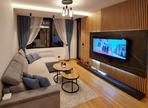 a living room with a couch and a flat screen tv at Zlatibor luxury residence, near the center in Zlatibor
