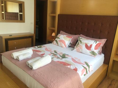 a bedroom with a bed with two pillows on it at Grand Central Apartment LTH in Tirana