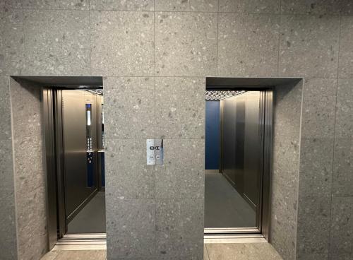two elevators in a lobby of a building at CASTLE HILL apt in Old Town of Bratislava with free parking in Bratislava