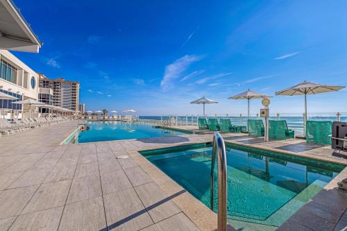 a swimming pool with a view of the ocean at Daytona Grande Oceanfront Resort in Daytona Beach