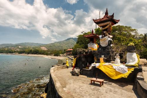 a temple on the shore of a body of water at The Oberoi Beach Resort, Lombok in Tanjung