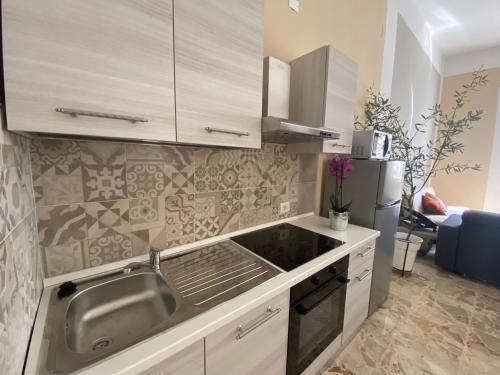 a kitchen with a sink and a refrigerator at La Bellavista Decameron View in Certaldo