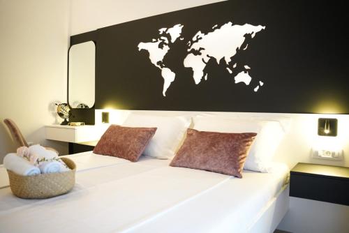 a bedroom with a white bed with a world map on the wall at Villa Istra Relax Diamond in Rebići