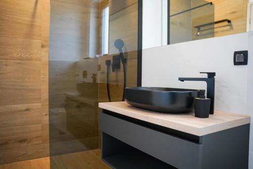 a bathroom with a black sink on a counter at Villa Istra Relax Diamond in Rebići