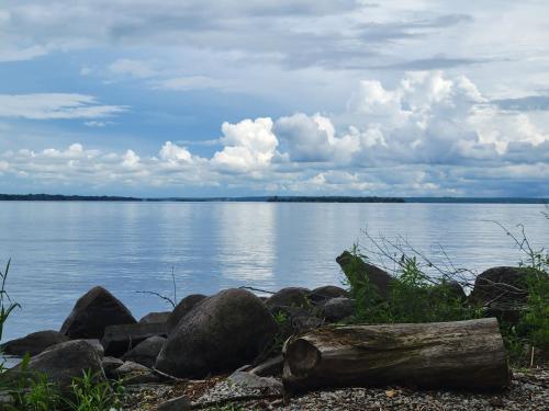 a view of a large body of water with rocks at Unique waterfront house with private beach in Gananoque