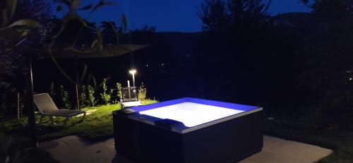 a hot tub in the middle of a yard at night at Carmen de Nella Eco Lodge 4* in Caprino Veronese