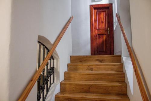 a stairway with a wooden door and a stair case at At the Blue Lion & Parking Assistance in Prague