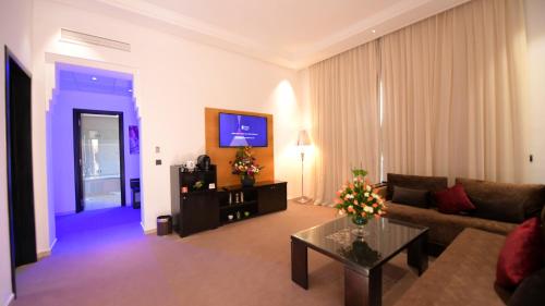 a living room with a couch and a table at El Olivar Palace Marrakech All Inclusive, Aquapark & SPA in Marrakech