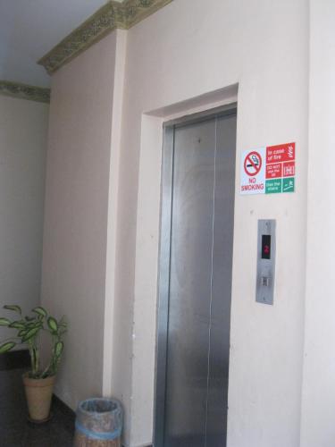 an elevator in a building with a no smoking sign at Langkawi Baron Hotel in Kuah