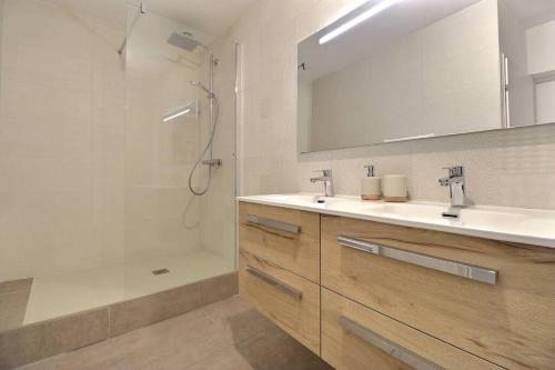 a bathroom with a shower and a sink and a mirror at La Veore - Baby-foot in Chabeuil