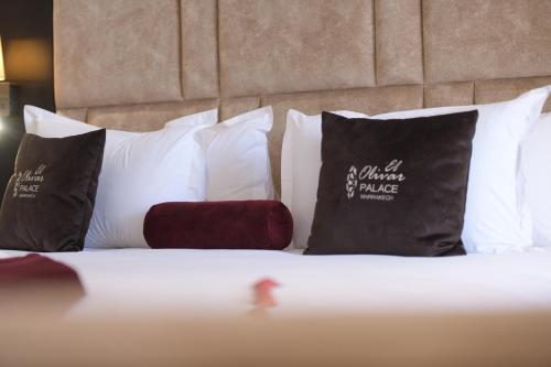 a close up of a bed with pillows on it at El Olivar Palace Marrakech All Inclusive, Aquapark & SPA in Marrakech