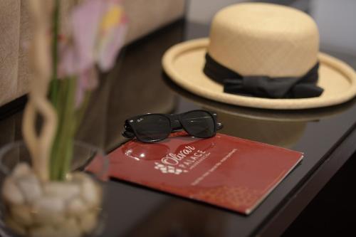 a hat and sunglasses sitting on top of a table at El Olivar Palace Marrakech All Inclusive, Aquapark & SPA in Marrakech