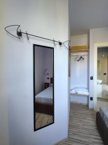 a mirror in a room with a bed and a bathroom at Aminta Apartment in Valtesse