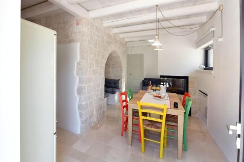 a kitchen and dining room with a table and chairs at Trulli di Titti - Luxury Country House in Castellana Grotte