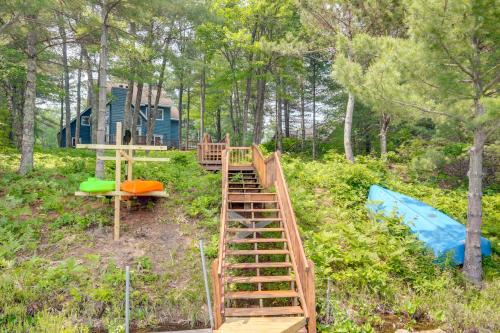 a wooden staircase leading to a tree house in the woods at Lakefront Minocqua Getaway Dock, Game Room! in Minocqua