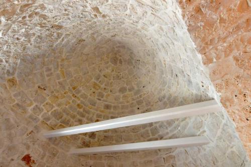 an overhead view of a stone wall with two shelves at Trulli di Titti - Luxury Country House in Castellana Grotte