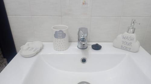 a bathroom counter with a sink with items on it at LUANTO in Conil de la Frontera