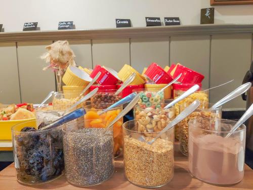 a table topped with glasses of different types of food at Mercure Curitiba Batel in Curitiba