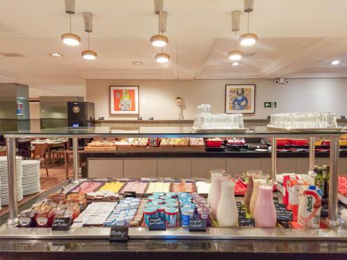 a buffet line with many different types of food at Mercure Curitiba Batel in Curitiba