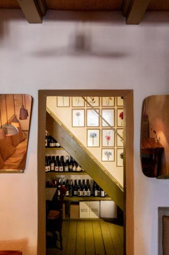 a stairway leading to a room with wine bottles at La Malvina ~5* centro storico~ Giardinetto privato in Santarcangelo di Romagna