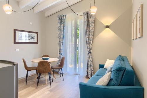 a living room with a blue couch and a table at La Casa dei Glicini in Levanto