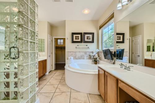 a bathroom with a tub and a sink and a shower at The Winner's Getaway in Las Vegas